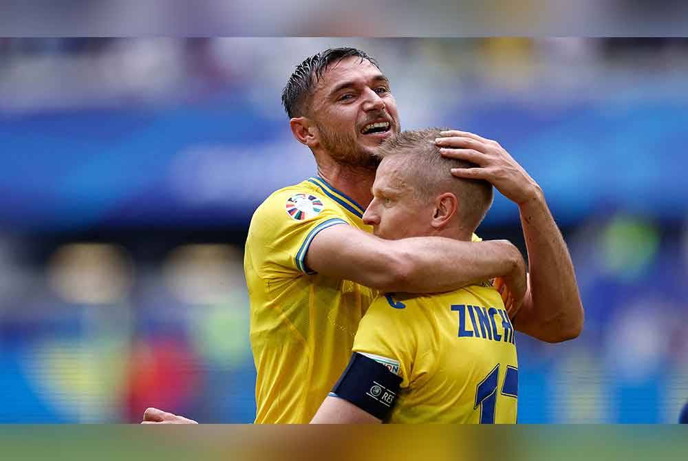 Yaremchuk merikan jaringan bersama Oleksandr Zinchenko selepas meledak jaringan di Duesseldorf Arena, Duesseldorf. Foto: AFP