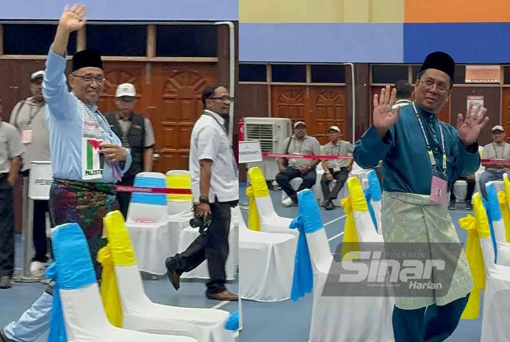 Calon Kerajaan Perpaduan, Dr Joohari Ariffin (kiri) dan Calon Perikatan Nasional, Abidin Ismail (kanan) masuk ke Dewan Serbaguna Jawi untuk menyerahkan borang pencalonan pada Sabtu.