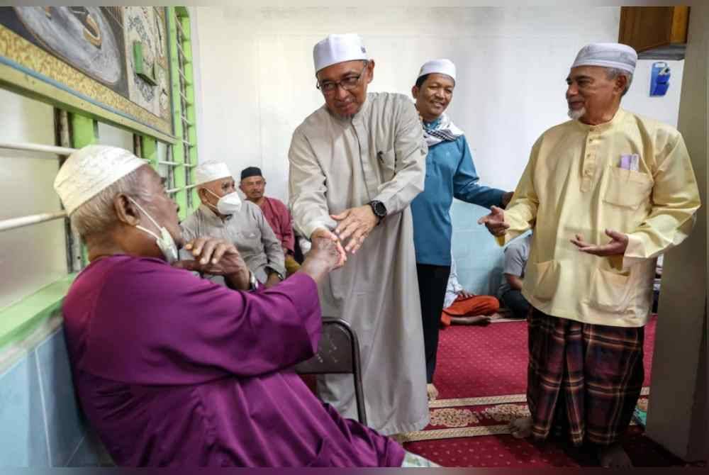 Calon Pakatan Harapan (PH), Dr Joohari Ariffin beramah mesra bersama jemaah yang hadir menunaikan solat Jumaat di Masjid Kampung Besar. Foto Bernama