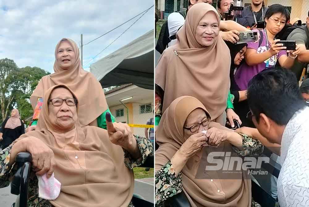 Abidin (kanan) bertemu dengan ibunya sebaik tiba di pusat mengundi SK Sungai Duri untuk membuang undi pada pagi Sabtu.