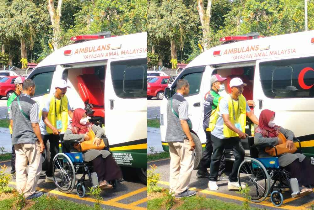 Rosnah dibantu petugas SPR sebaik turun dari ambulans untuk mengundi di SK Sungai Duri sempena PRK Sungai Duri pada pagi Sabtu.