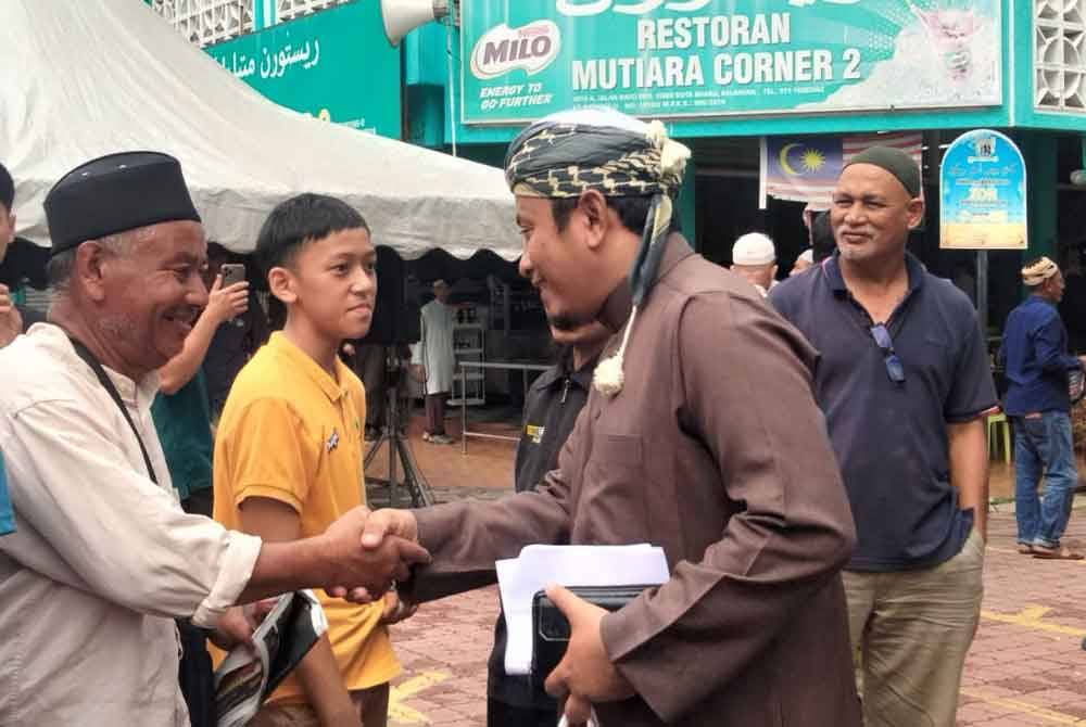 Ahmad Fadhli (kanan) bertemu orang ramai yang menghadiri kuliah Jumaat di Medan Ilmu.