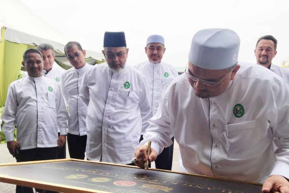 Mohamed Fadzli menandatangani plak bagi merasmikan Kilang Paip Kel-Intaaj HDPE Sdn Bhd di sini pada Rabu.