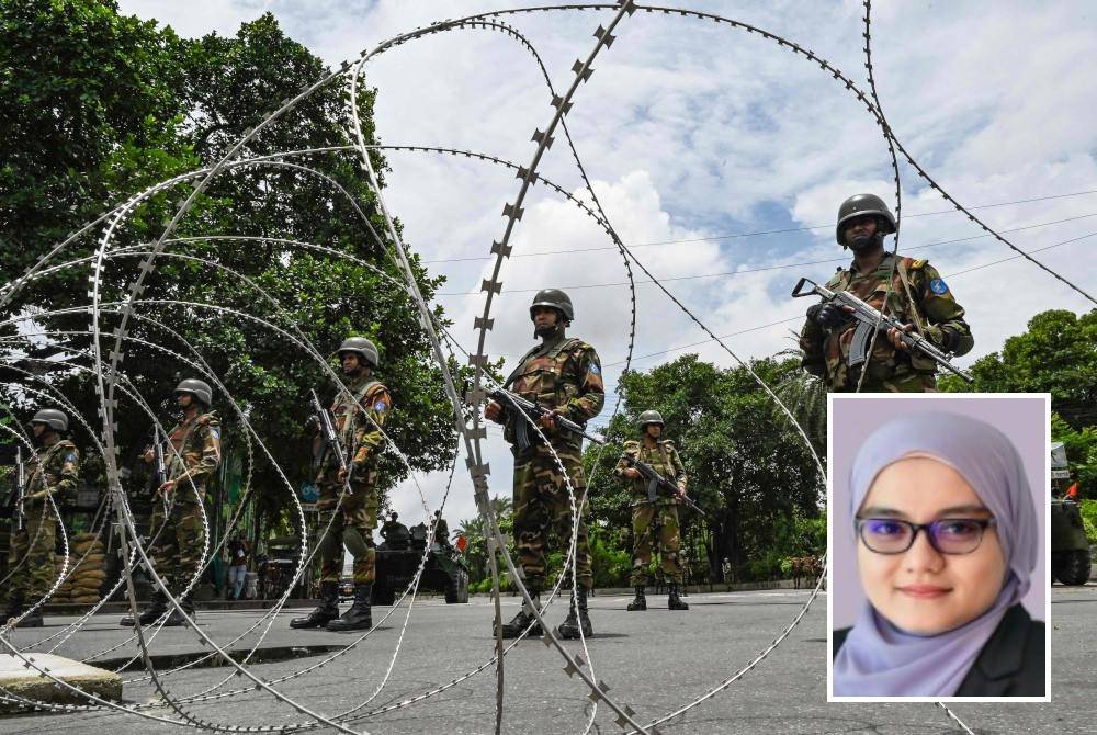 Anggota tentera Bangladesh berkawal berhampiran bangunan Parlimen di tengah-tengah perintah berkurung berikutan pertempuran antara polis dan penunjuk perasaan di Dhaka pada 22 Julai lalu. Foto AFP (Gambar kecil: Shahidah)