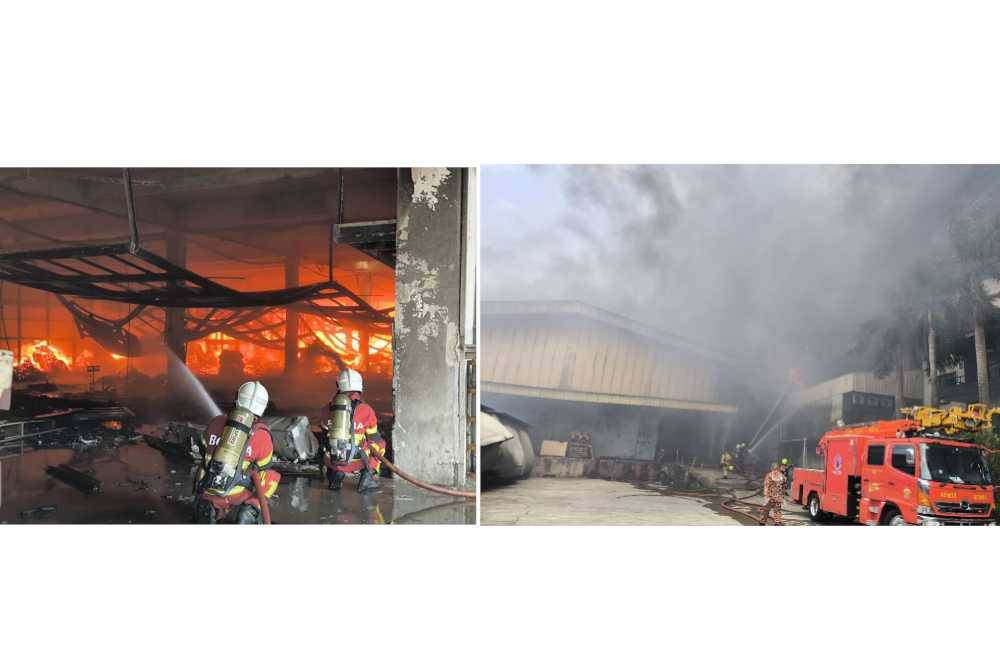 Anggota bomba sedang memadamkan kebakaran kilang perabot dekat Kampung Baru Sungai Buloh di sini pada Ahad.