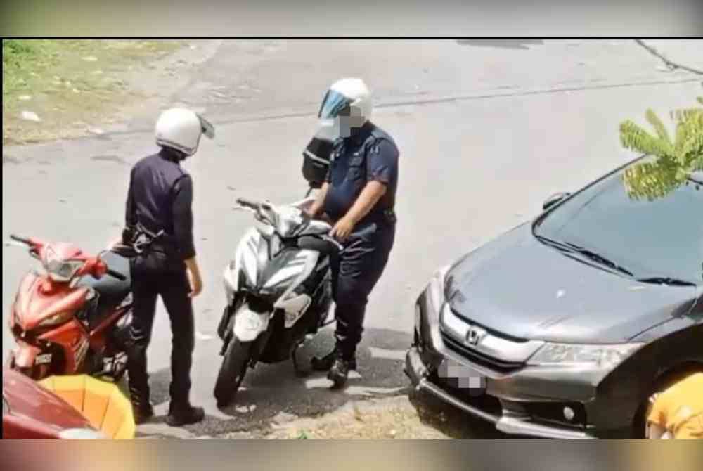 Tangkap layar video tular memaparkan dua anggota polis dipercayai melakukan pemerasan wang ke atas warga asing di Jalan Taming Sari, di sini.
