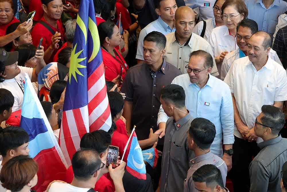 Anwar bersalaman dengan orang ramai selepas merasmikan Konvensyen Keadilan Sabah di Pusat Konvensyen Antarabangsa Sabah, hari ini. Foto Bernama