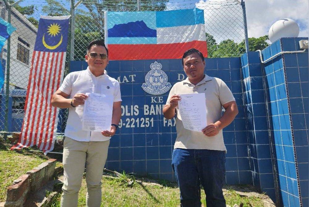 Willy Frous (kiri) bersama rakannya membuat laporan polis di Sandakan.