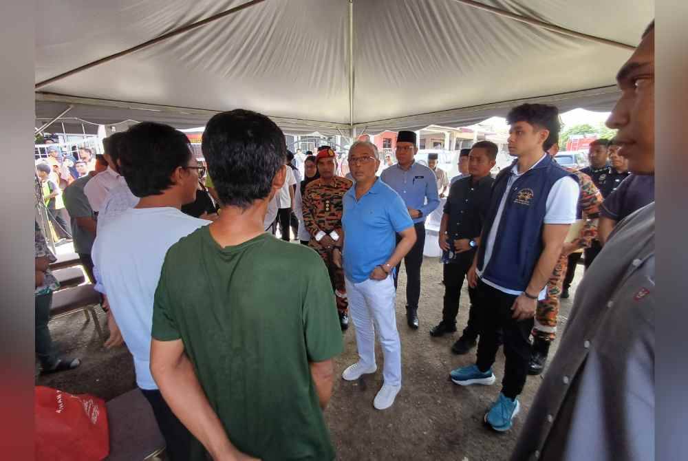 Tengku Hassanal (kiri) bersama Al-Sultan Abdullah ketika berkenaan mencemar duli melawat mangsa kebakaran tiga buah rumah teres di Taman Kempadang Makmur, di sini pada Isnin.