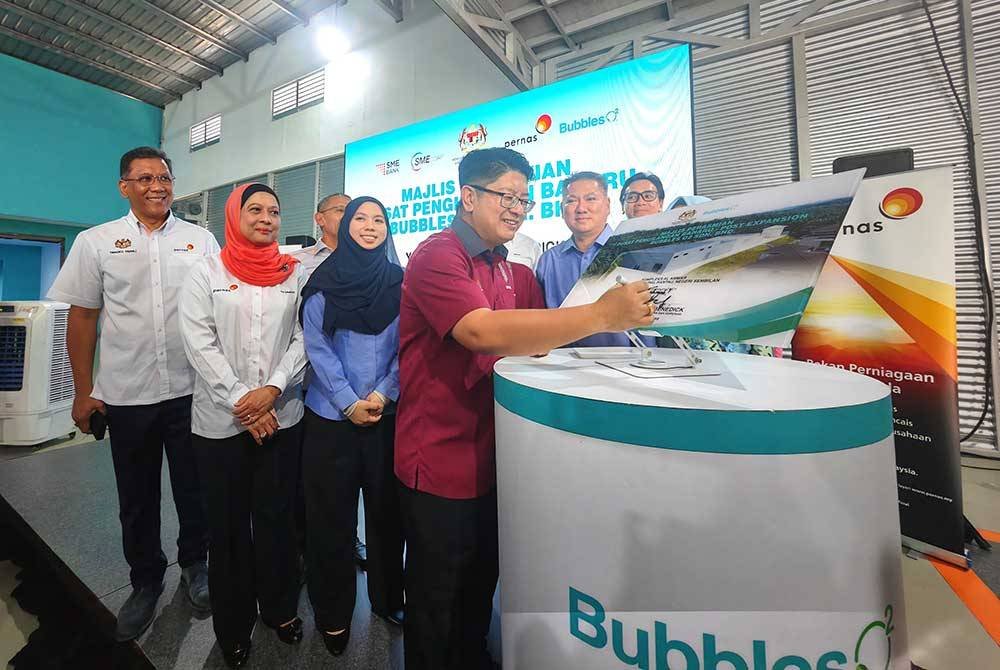 Ewon menandatangani plak perasmian kilang baharu Bubbles 02 pada Khamis