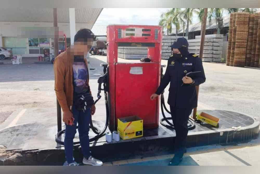 Pegawai KPDN memeriksa pam minyak diesel yang didapati menjual melebihi 2 sen daripada harga ditetapkan kerajaan. Foto KPDN Perak