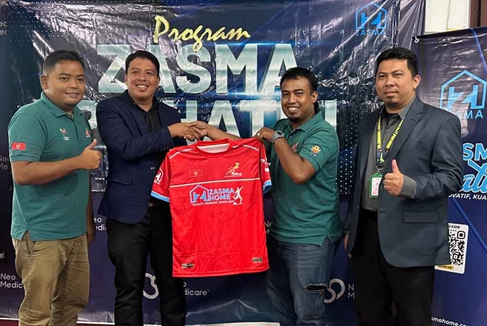 Penyerahan jersi oleh Muhammad Azrimi (dua dari kiri) kepada Kepten Pasukan Futsal Orang Pekak, Mohammad Rahmatuddin Mhd Huzaizi (dua dari kanan) sambil diiringi Saiful Helmie (kiri) dan Mohd Firdaus.