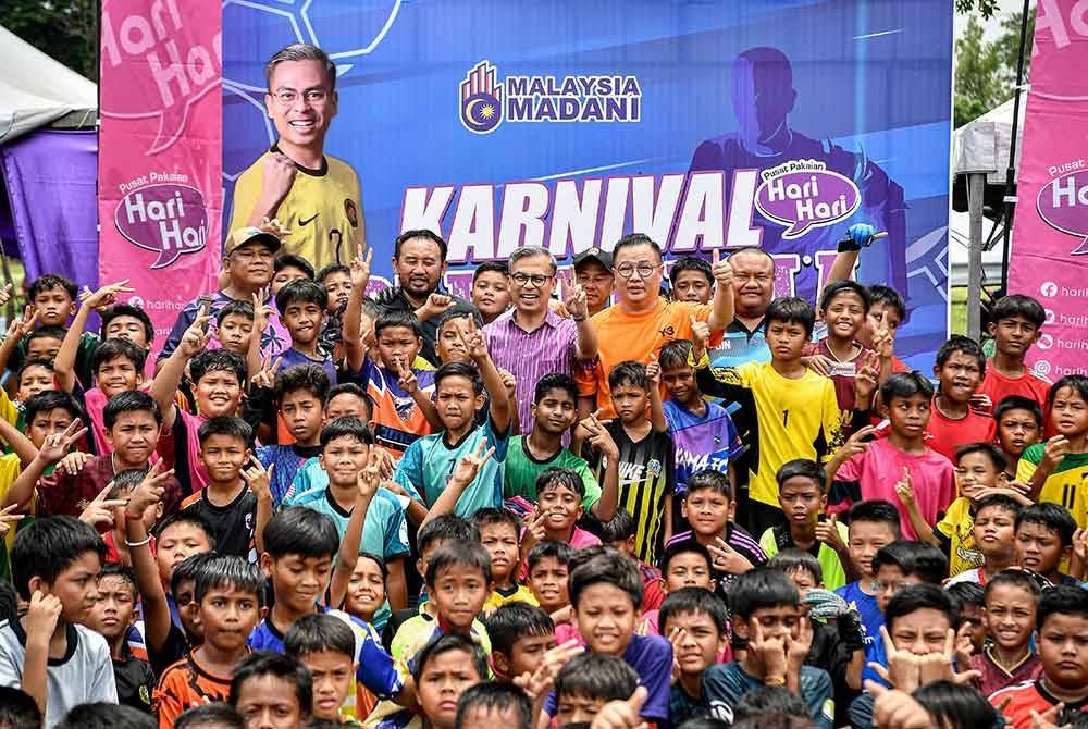 Fahmi merangkap Ahli Parlimen Lembah Pantai (tengah) bergambar bersama para peserta yang menyertai Karnival Hari-Hari Bola Piala Madani Lembah Pantai 2024 di Padang C, Universiti Malaya hari ini. Foto Bernama