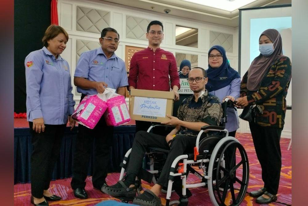 Mohammed Taufiq (tengah) menyerahkan faedah dan alat pemulihan kepada pencarum dalam Program Perkeso Bersama Pemimpin Masyarakat dan Seranta peringkat Pejabat Perkeso Sungai Petani 2024 pada Ahad.