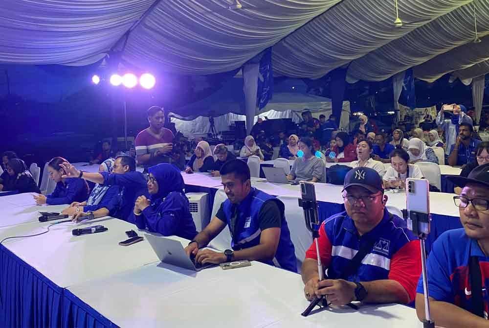 Petugas Bilik Gerakan Utama (BGU) Barisan Nasional (BN) sibuk dengan pengiraan undi tidak rasmi PRK Mahkota pada Sabtu.