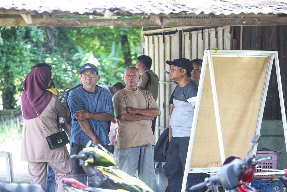 Ismail Baharom (dua kanan) hadir ke Markas SAR untuk mengetahui perkembangan kes adiknya Sabari Baharom di Kampung Lubuk Batu di sini pada Selasa.