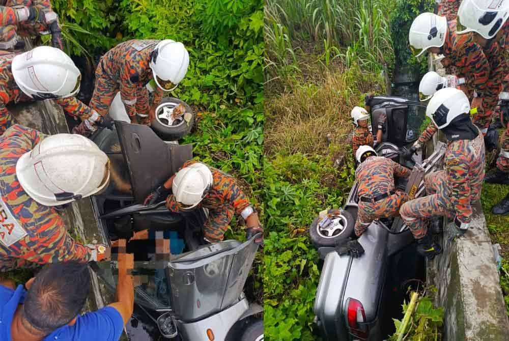 Anggota bomba mengeluarkan mangsa yang tersangkut di bahagian tempat duduk pemandu. Foto Bomba Perak