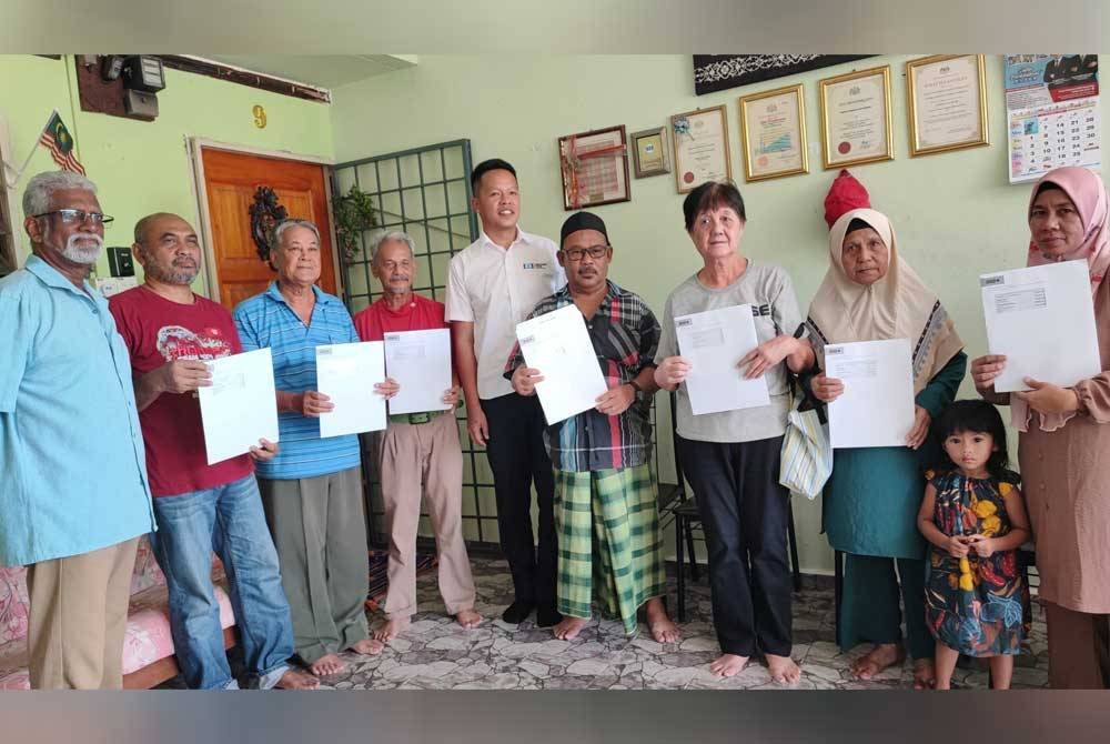 Chun Kuang (tengah) bersama sebahagian penerima tajaan insurans rumah ADUN Semambu pada sesi penyerahan pada Sabtu.