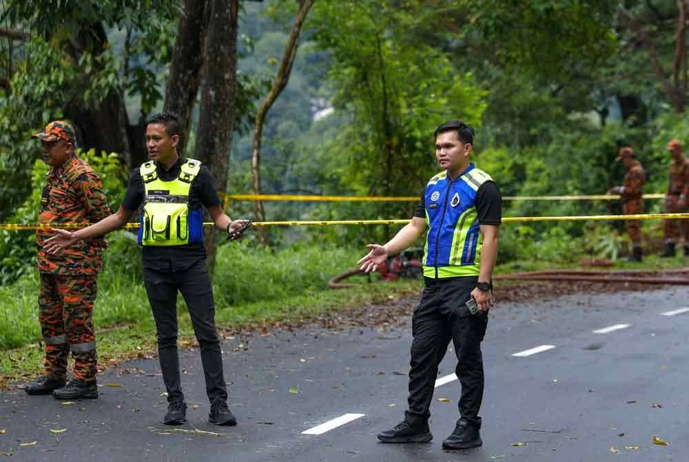 Anggota polis mengawal lokasi kejadian tanah runtuh di Jalan E6 Taman Melawati pada Selasa. Foto Bernama