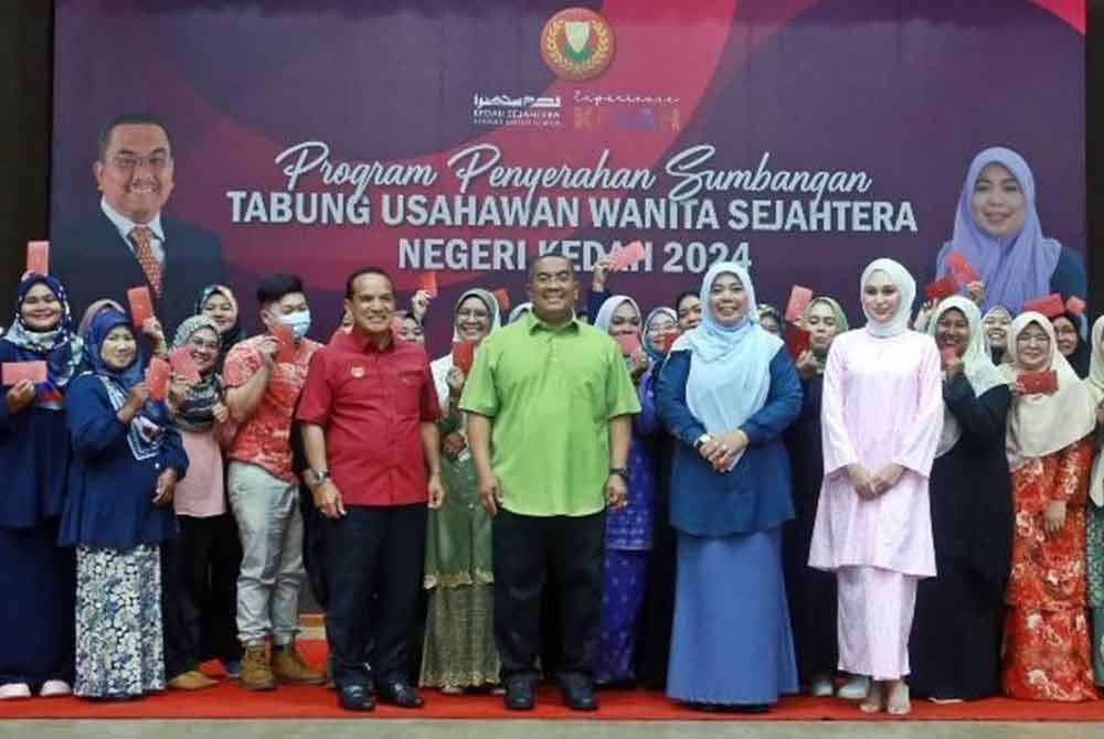 Sanusi (tengah) bersama sebahagian usahawan wanita Kedah yang menerima inisiatif Tabung Wanita Sejahtera di Dewan Seri Mentaloon.