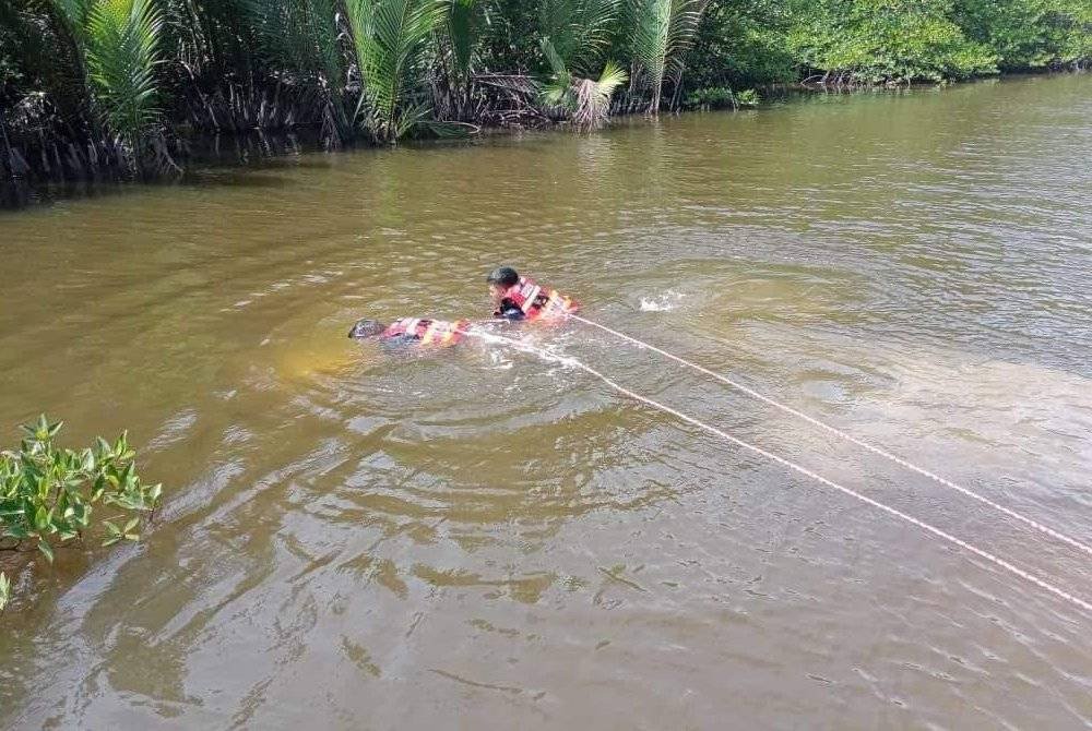 Anggota bomba menjalankan operasi mencari dan menyelamat di kawasan sungai di Kampung Awat-Awat, Jalan Awat-Awat, Sundar. Foto JBPM