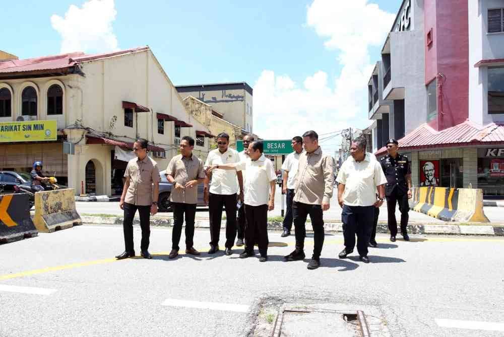 Ahmad (tiga dari kanan) meninjau keadaan penyuaraian baharu aliran trafik satu hala di pekan Tapah sempena lawatan kerjanya pada Sabtu.