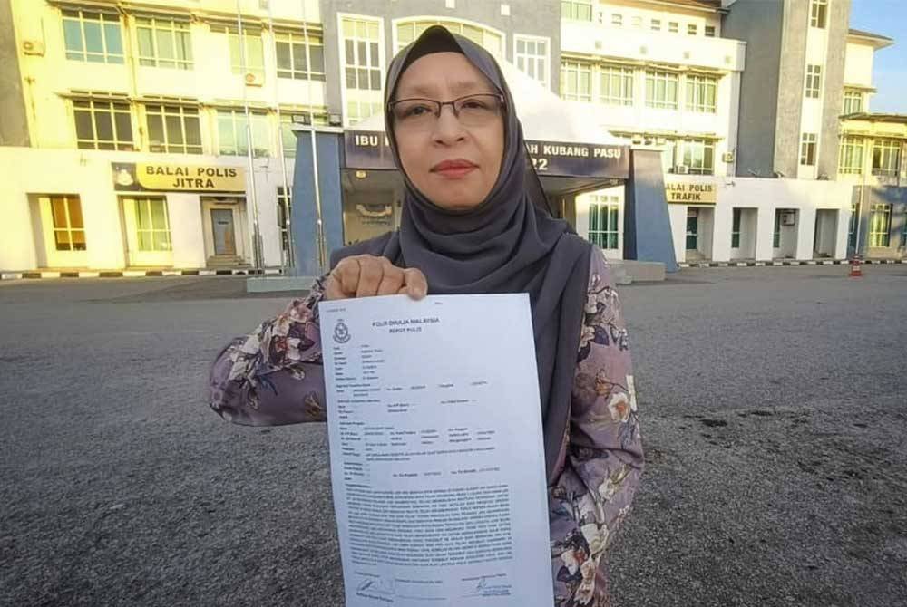 Zuraini menunjukkan laporan polis yang dibuat di IPD Kubang Pasu pada Isnin.