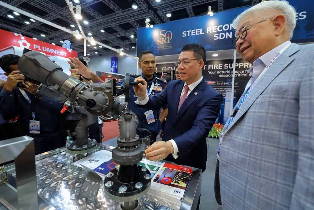 Nor Hisham (kiri) memberi penerangan kepada Kor Ming ketika melawat ruang pameran di IFCEM 2024 di Pusat Konvensyen Kuala Lumpur pada Selasa. Foto Bernama