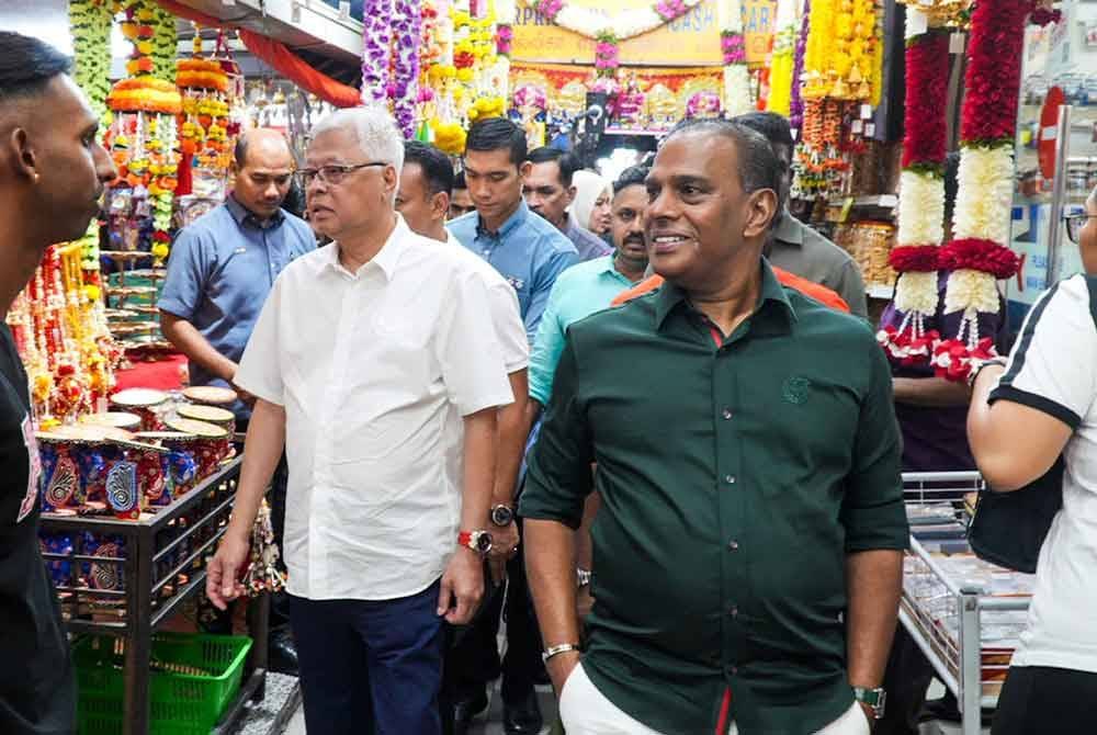 Ismail Sabri (tiga dari kiri) bersama Saravanan (dua dari kanan) ketika berkunjung ke Little India, Brickfields pada Rabu.