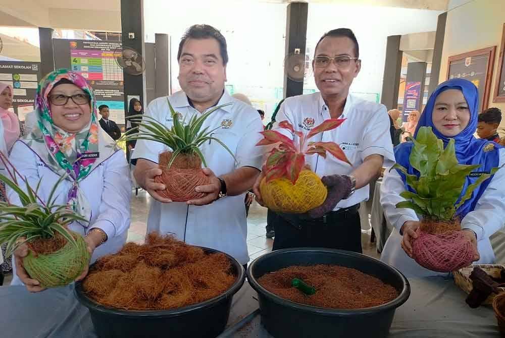 Wan Abdul Latiff (dua dari kanan) menunjukkan tanaman cocodema di Sekolah Kebangsaan (SK) Bukit Mutiara, Johor Bahru pada Selasa.