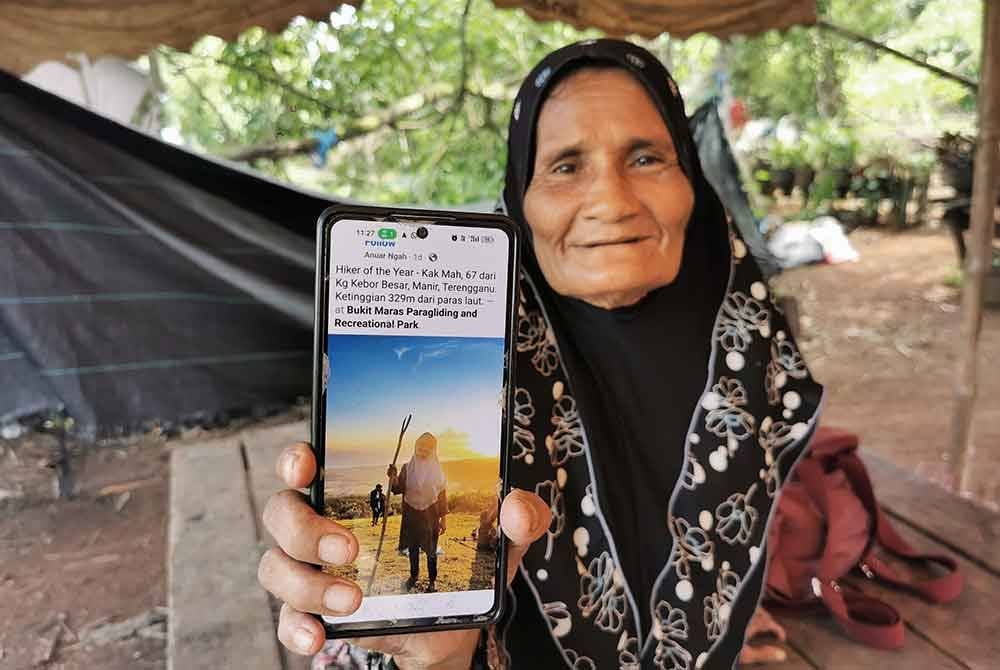 Fatimah menunjukkan gambarnya berjaya sampai sehingga ke puncak Bukit Maras di Kuala Nerus pada Jumaat lalu.