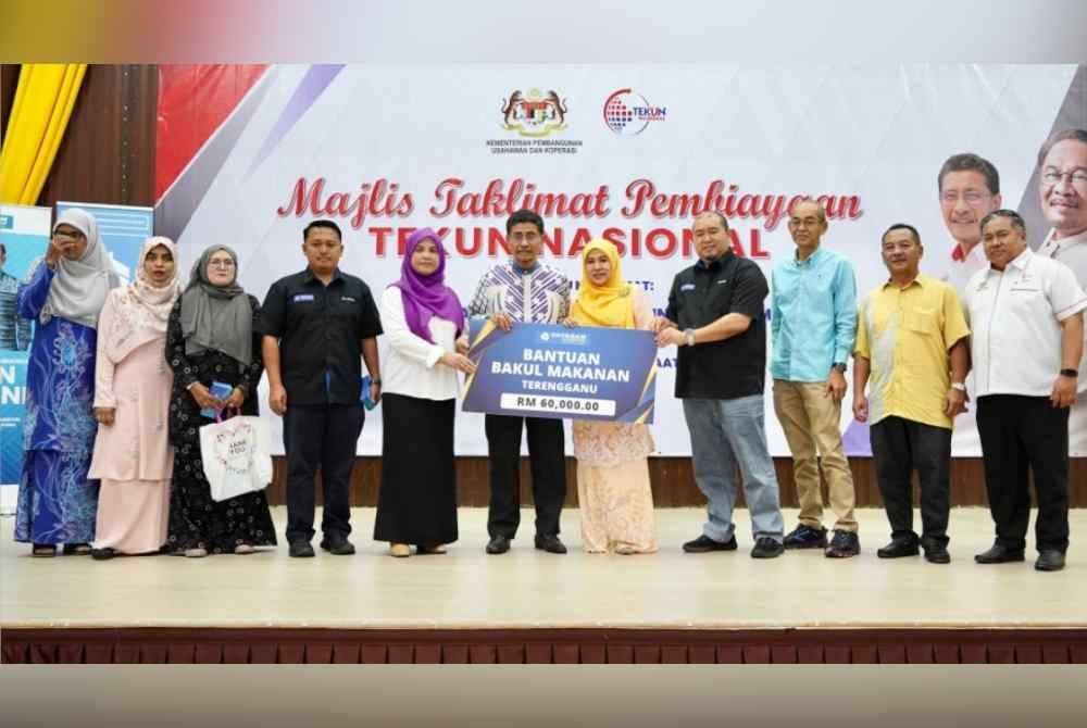 Ahli Lembaga Pemegang Amanah YBR, Datin Faizah Ariffin menyerahkan mock cheque kepada Pengerusi Persatuan Wanita Inspirasi Kuala Nerus Terengganu, Noor Suliyantie Che Sulaiman sebagai simbolik penyerahan Sumbangan Bantuan Bakul Makanan YBR di Terengganu.