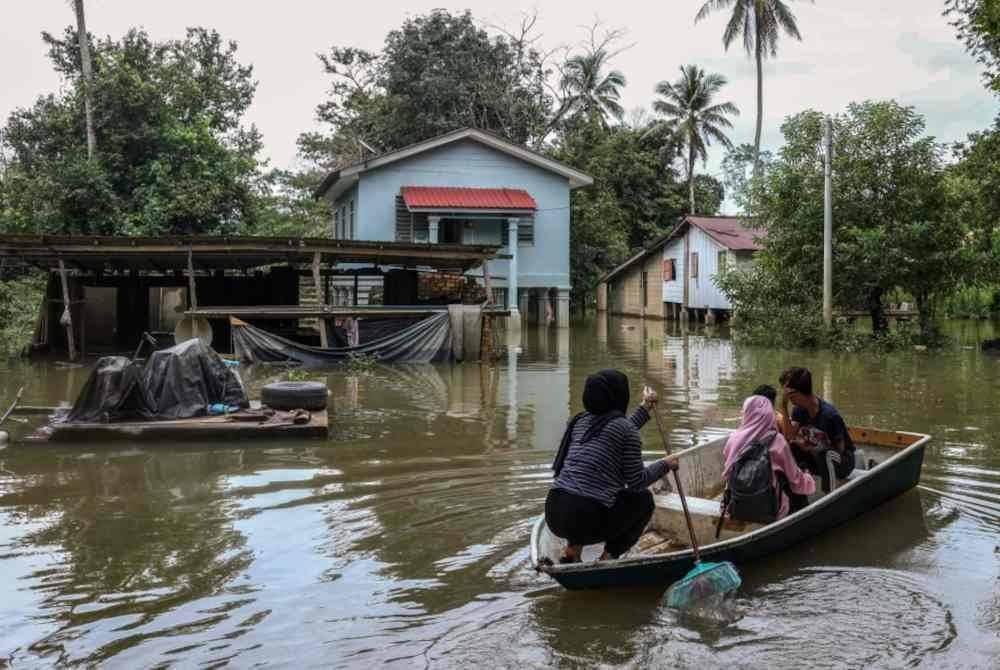 Penduduk menggunakan perahu untuk pulang ke kediaman masing-masing ketika tinjauan Bernama di sini hari ini. Foto Bernama