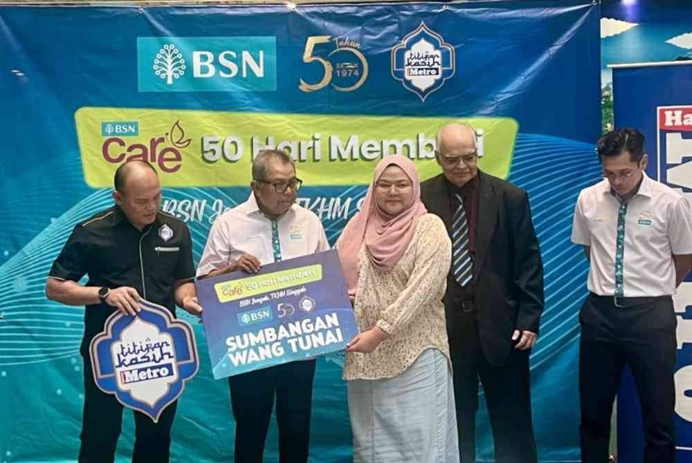 Pengerusi BSN, Datuk Seri Dr Awang Adek Hussin (dua kiri) menyampaikan sumbangan kepada Roshila Murni (dua kanan).