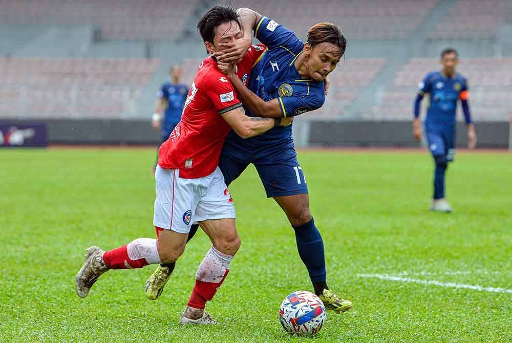 Pemain import Sabah dari Korea Selatan, Kwang Min-ko diasak pemain PT Athletic FC Amri Yahyah (kanan) dalam aksi timbal balik pertama di Cheras sebelum ini.