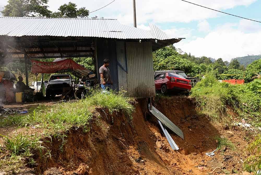 Keadaan tanah runtuh berdekatan bengkel milik penduduk berikutan hujan lebat pada musim tengkujuh di Simpang Jerek di sini. Foto Bernama