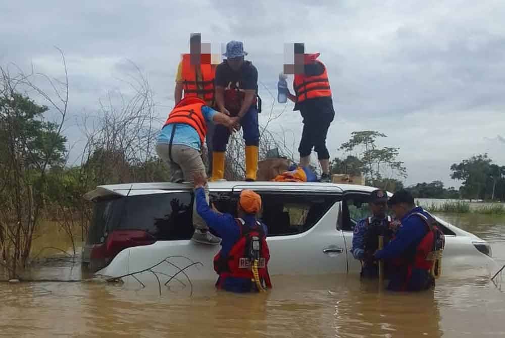 Anggota APM Segamat membantu mangsa di Kampung Pagoh Tengah. - Foto APM Segamat