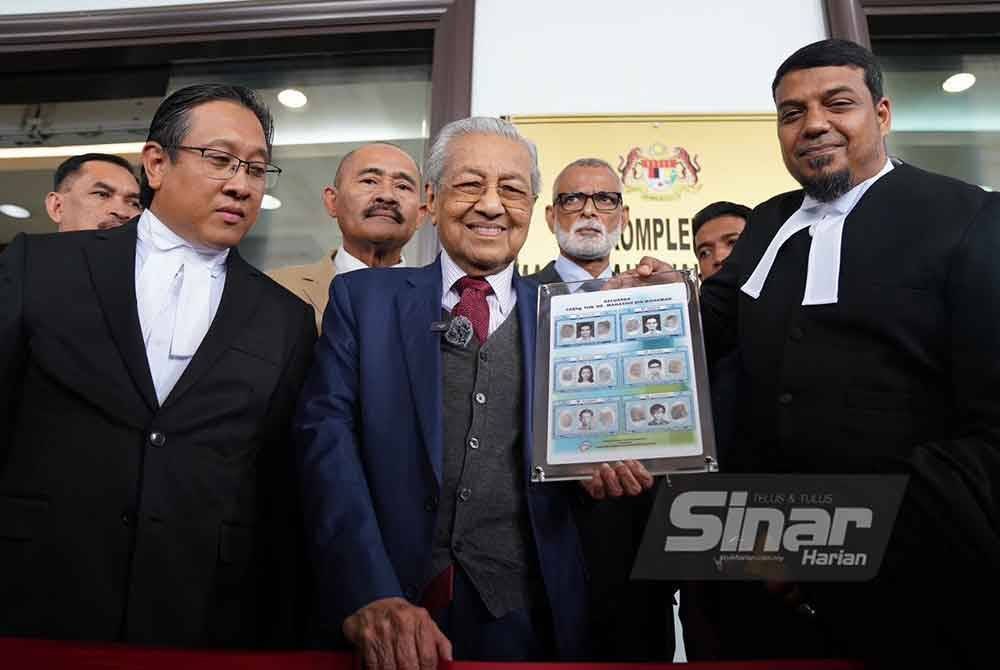 Tun Dr Mahathir Mohamad menunjukkan beberapa salinan dokumen termasuk kad pengenalan lama miliknya, isteri dan empat anaknya berserta surat beranak asal bagi membuktikan nama sebenarnya. FOTO: SINAR HARIAN - ROSLI TALIB