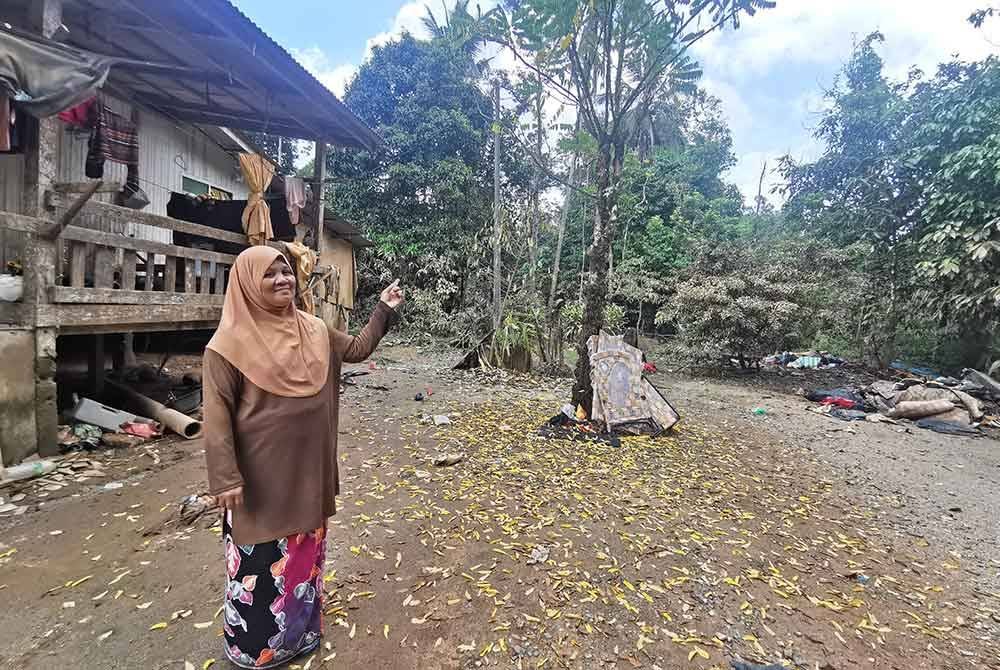 Fatimah menunjukkan kawasan rumahnya yang dinaiki air sedalam 8 meter dalam kejadian pada 29 November lalu.