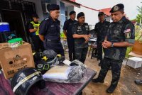 Ayob Khan (kanan) meninjau keadaan rumah anggota yang terjejas banjir ketika mengadakan lawatan kerja ke Perumahan Seri Bayu. Foto Bernama