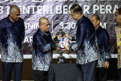 Saarani (dua dari kiri) menandatangani bola sebagai gimik pelancaran Kejohanan Bola Sepak Perak Sejahtera Piala Menteri Besar Perak di sebuah hotel di Ipoh pada Isnin.