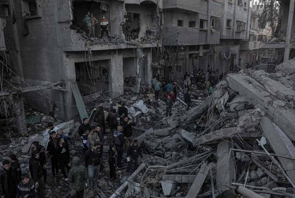 Orang ramai berkumpul di tapak bangunan yang musnah selepas serangan udara Israel di kem pelarian al-Nuseirat, tengah Semenanjung Gaza pada 13 Disember 2024. Foto fail Xinhua