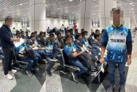 Pegawai imigresen memeriksa warga Bangladesh yang ditahan selepas didapati menyamar sebagai pelatih Akademi Perikanan di Lapangan Terbang Antarabangsa Kuala Lumpur (KLIA) di sini pada Jumaat.