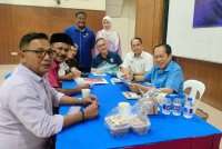 Ahmad (kanan) ketika program bertemu rakyat Parlimen Pontian di Dewan Serbaguna Benut pada Sabtu.