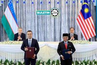 ANWAR (duduk, kanan) bersama Shavkat Mirziyoyev (duduk, kiri) menyaksikan pertukaran dokumen persefahaman di antara Menteri di Jabatan Perdana Menteri (Hal Ehwal Agama), Datuk Dr Mohd Na&#039;im Mokhtar (depan, kanan) dan Menteri Pelaburan, Industri dan Perdagangan Uzbekistan, Laziz Kudratov di Putrajaya baru-baru ini. - Foto: BERNAMA